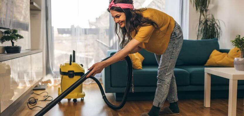 Professional cleaner vacuuming a living room in a Dublin home